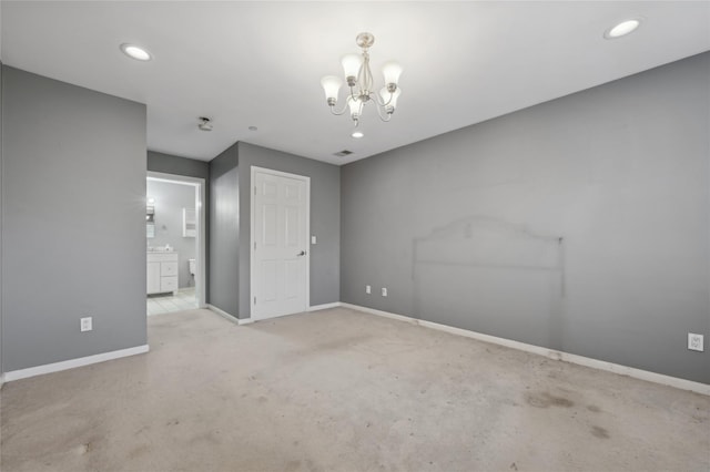 unfurnished room with light carpet and a chandelier