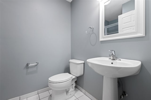 bathroom with tile patterned flooring and toilet