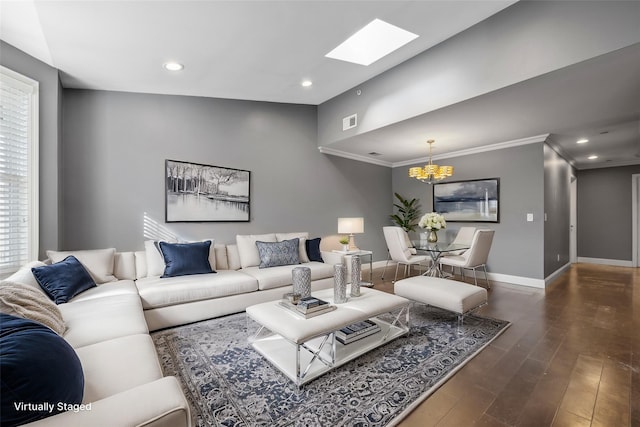 living room with a skylight, a wealth of natural light, dark wood-type flooring, and ornamental molding