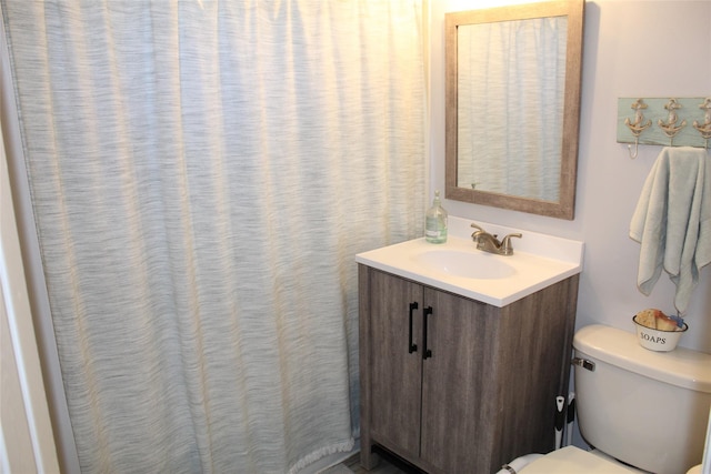 bathroom featuring vanity and toilet