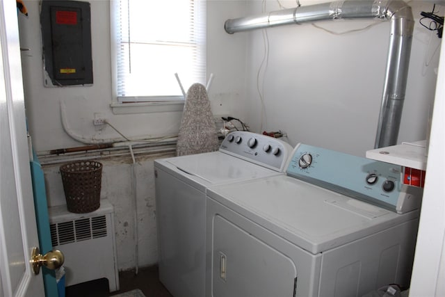 washroom with radiator, electric panel, and washing machine and clothes dryer