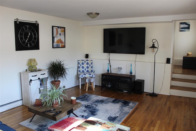 living room with baseboard heating and dark hardwood / wood-style floors