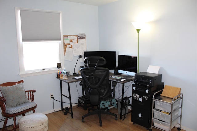 home office with wood-type flooring