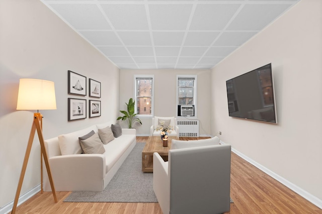 living room featuring radiator heating unit and light wood-type flooring