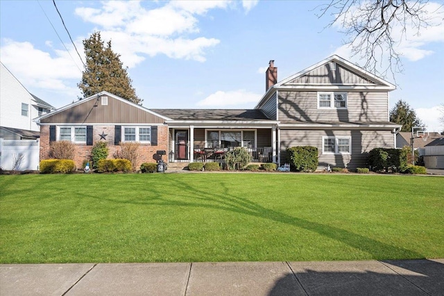 view of front of house with a porch and a front lawn