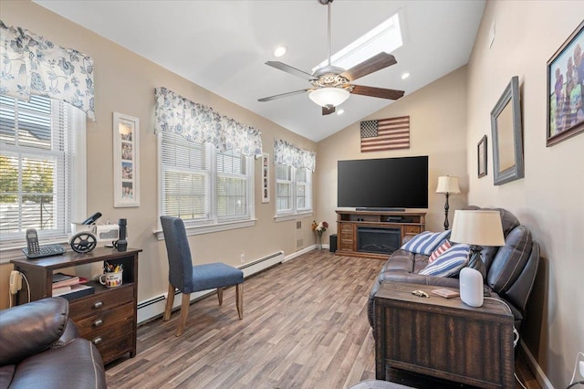 living room with light hardwood / wood-style flooring, vaulted ceiling, a baseboard radiator, and ceiling fan