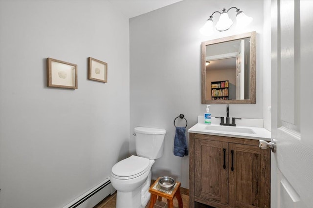 bathroom featuring a baseboard radiator, vanity, and toilet