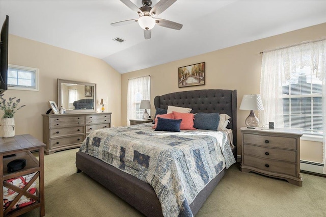 bedroom featuring a baseboard heating unit, vaulted ceiling, light colored carpet, and ceiling fan