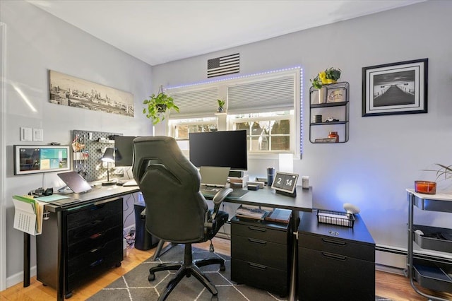 office featuring hardwood / wood-style floors and baseboard heating