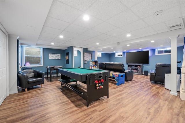 recreation room featuring a baseboard radiator, pool table, a drop ceiling, and light wood-type flooring