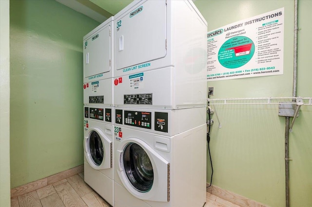 washroom with washing machine and clothes dryer, stacked washer and clothes dryer, and light hardwood / wood-style flooring