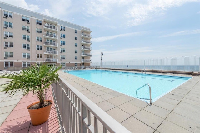 view of pool featuring a water view