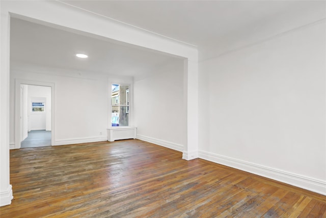 spare room with dark hardwood / wood-style flooring