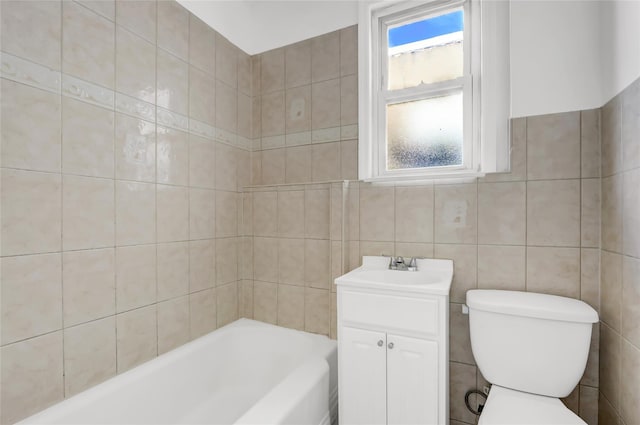 bathroom featuring vanity, toilet, tile walls, and a washtub