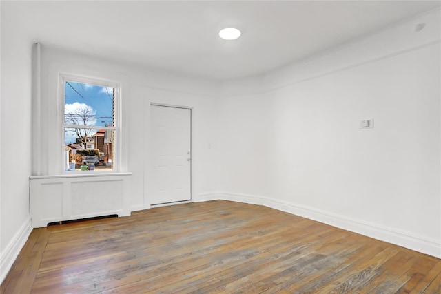 unfurnished room with hardwood / wood-style floors