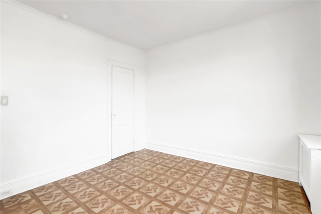 unfurnished room with ornamental molding and parquet flooring