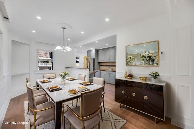 dining room with dark wood-type flooring and a chandelier