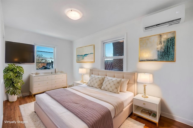 bedroom featuring hardwood / wood-style flooring and a wall mounted air conditioner