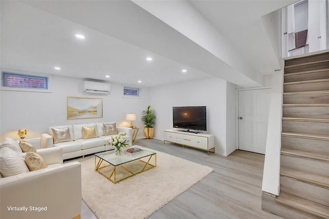 living room with hardwood / wood-style flooring and a wall mounted AC