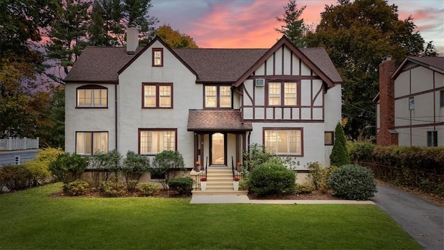 tudor house featuring a lawn