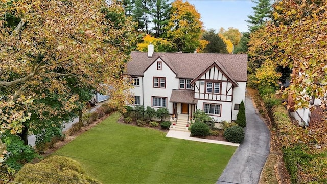 tudor house featuring a front lawn