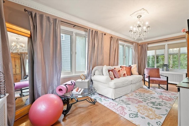 living room featuring radiator, hardwood / wood-style floors, and a chandelier