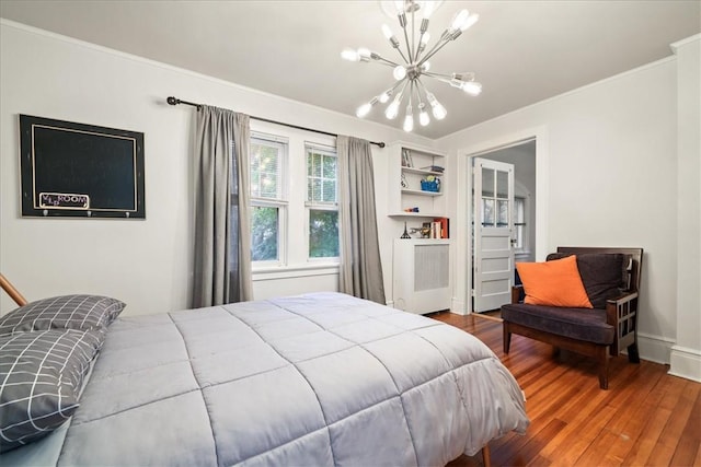 bedroom featuring a notable chandelier, hardwood / wood-style flooring, and ornamental molding