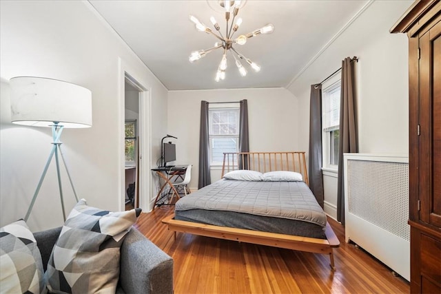 bedroom with light hardwood / wood-style flooring and a notable chandelier