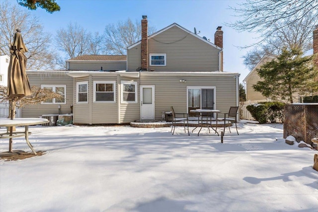 view of snow covered rear of property