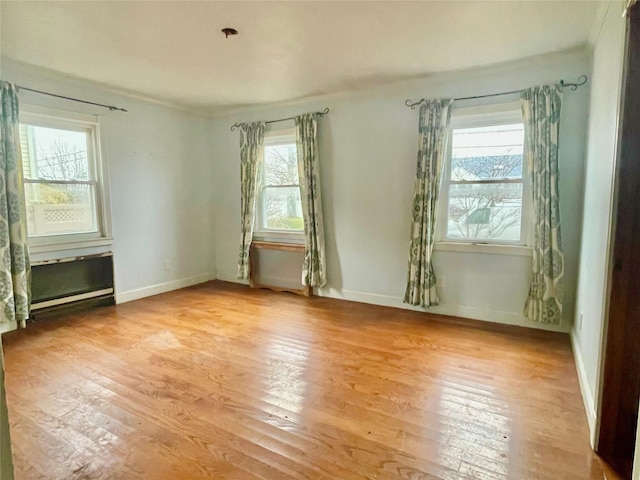 empty room with light hardwood / wood-style flooring