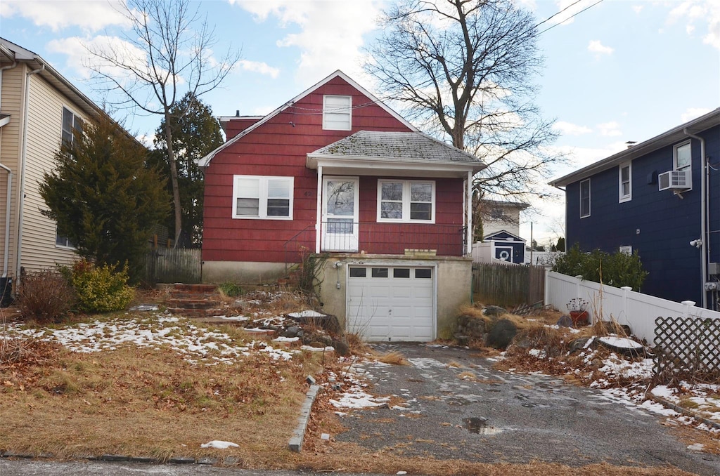 view of front of property featuring cooling unit and a garage