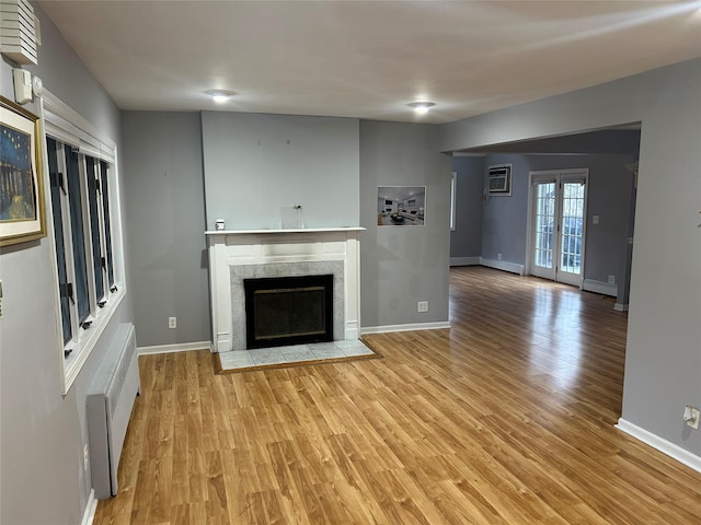 unfurnished living room with a premium fireplace and light wood-type flooring