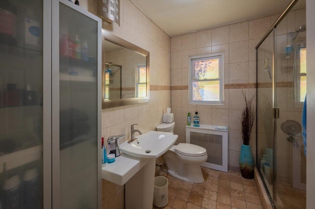 bathroom featuring radiator, tile walls, and an enclosed shower