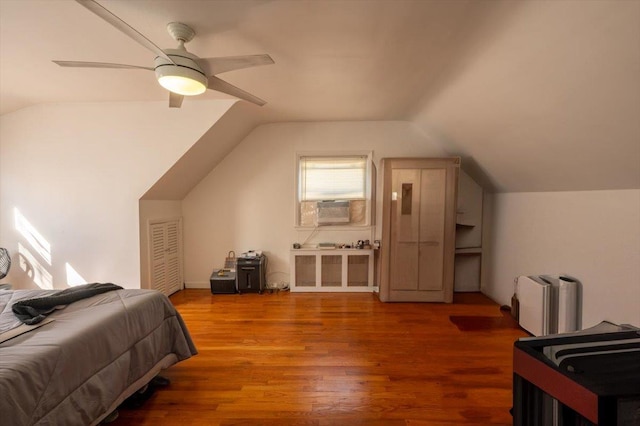 bedroom featuring lofted ceiling, hardwood / wood-style floors, cooling unit, and ceiling fan