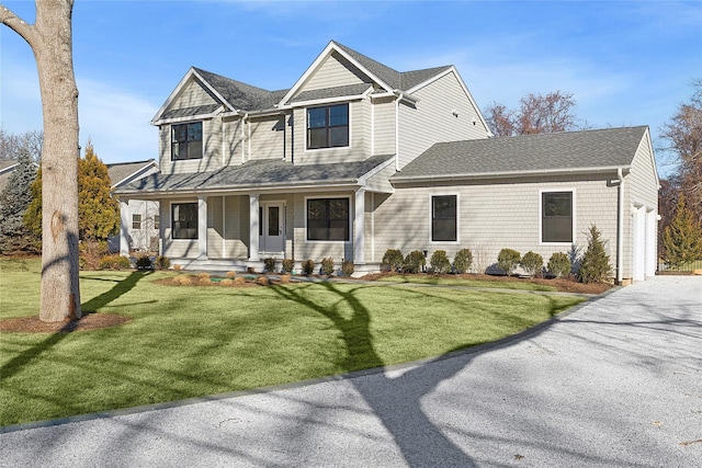 view of front of house with a porch and a front yard