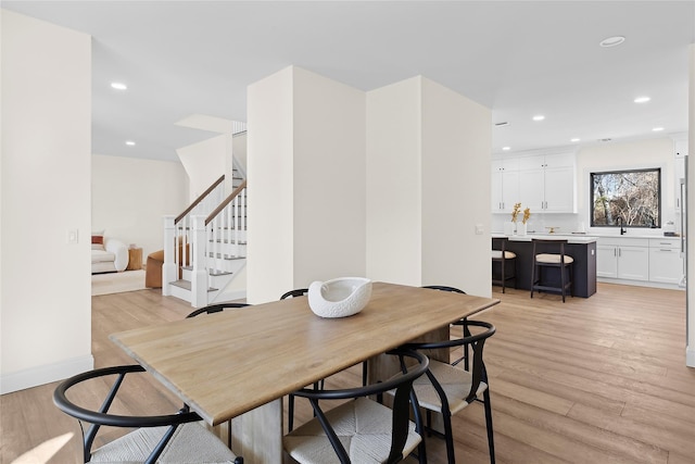 dining space with light hardwood / wood-style floors