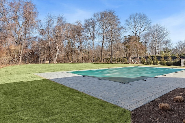 view of pool with a yard and a patio