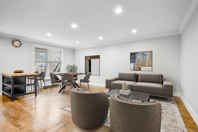 living room with ornamental molding and light hardwood / wood-style flooring