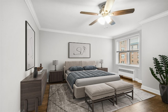 bedroom featuring hardwood / wood-style flooring, ceiling fan, radiator heating unit, and crown molding