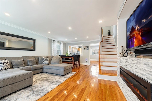 living room with hardwood / wood-style floors and ornamental molding