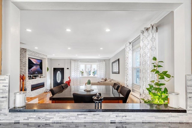 dining space with crown molding and wood-type flooring