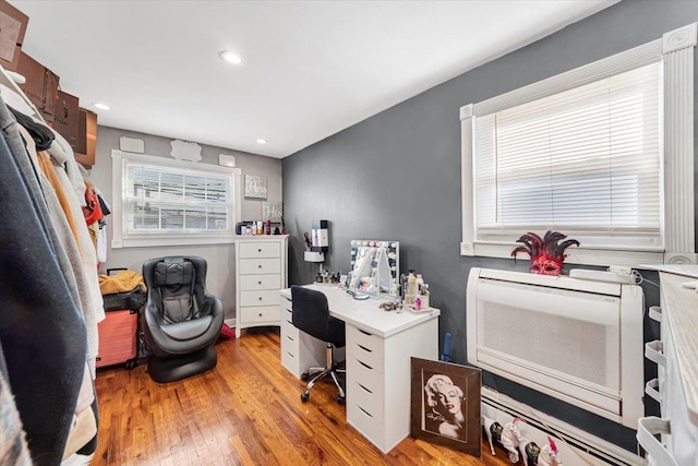 office area featuring heating unit and light hardwood / wood-style flooring