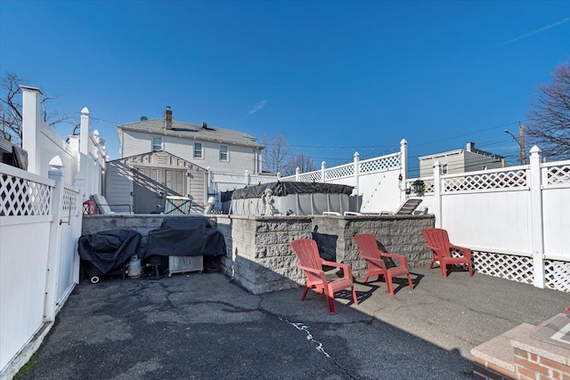 view of patio / terrace with a storage unit