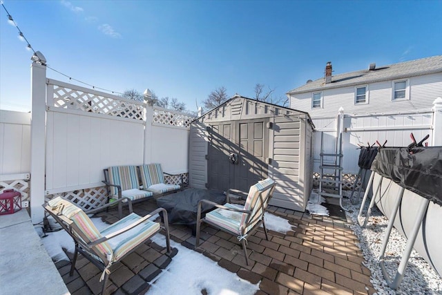 view of patio / terrace with a shed