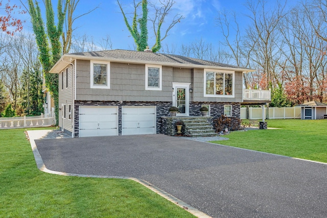 raised ranch with a garage and a front yard