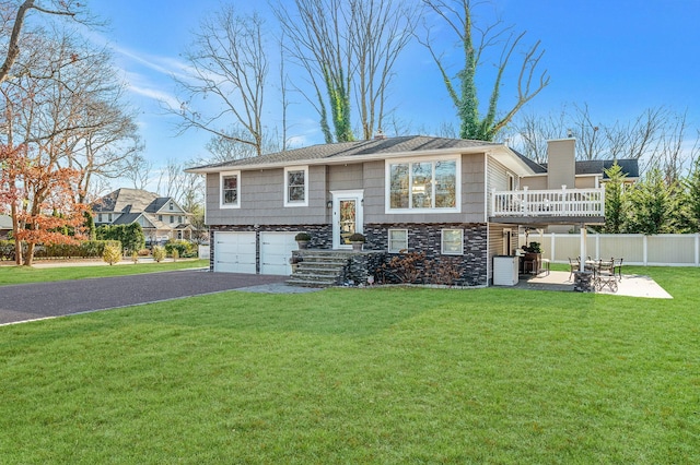 view of front facade featuring a garage, a front yard, and a patio