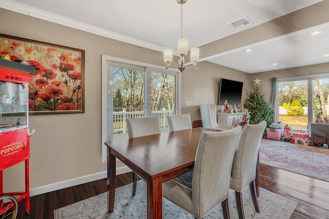 dining room featuring ornamental molding, a chandelier, and hardwood / wood-style floors