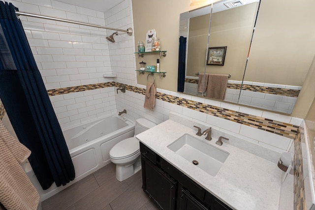 full bathroom with shower / bathtub combination with curtain, vanity, tile walls, and toilet