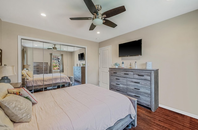 bedroom featuring ceiling fan, dark hardwood / wood-style floors, and a closet