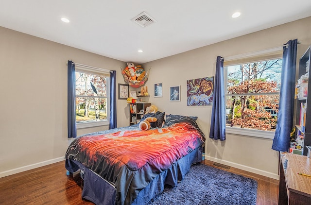 bedroom with dark hardwood / wood-style floors